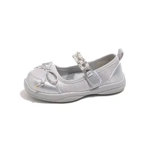 Shiny silver princess shoes for girls featuring a delicate bow and rhinestone pearl strap