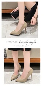 Elegant nude patent leather stiletto pumps shown on model with pointed toe.