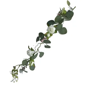 Close-up view of a high-quality artificial eucalyptus vine with white French roses.