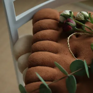 Close-up detail of a soft brown biscuit-shaped plush seat cushion for home or office chairs