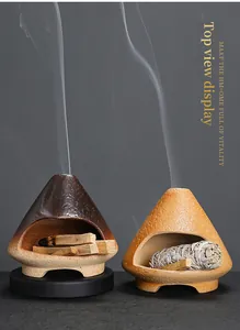 Close-up of ceramic fireplace incense burners for Palo Santo wood and white sage bundles