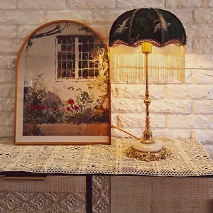 Detailed view of an ivory hollow lace table runner styled on a vintage wooden storage cabinet