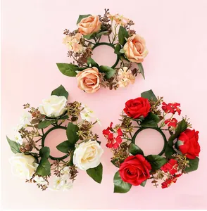 Detailed top view of three artificial rose candle rings in peach, white, and red colors.