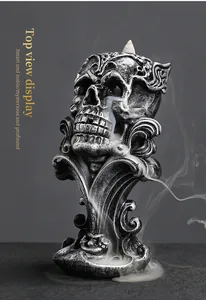 Detail view of gothic resin skull backflow incense burner showing smoke flow effect