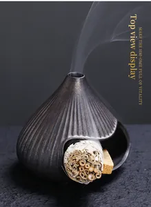 Close-up of ceramic mountain incense burner burning white sage and holy Palo Santo wood