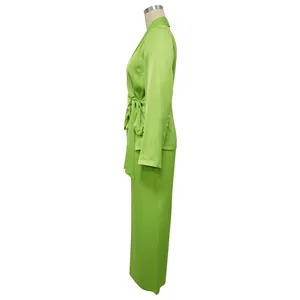 Side view of lime green two-piece suit set with belted blazer and wide leg pants