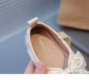 Primer plano de zapatos de princesa para bebé con lazo de perlas y plantilla acolchada