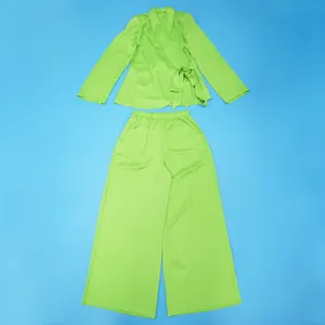 Flat lay detail of a lime green two-piece suit with wrap top and wide-leg trousers