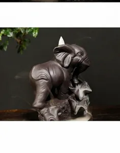 Macro view of elephant backflow incense burner made of zisha ceramic with smoke