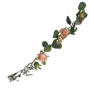 Detail view of artificial French rose and eucalyptus vine garland for home decor.