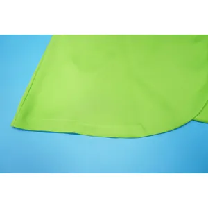 Macro view of neon green fabric showing precise hem stitching and smooth texture.