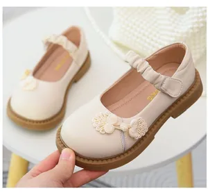 Détail de chaussures Mary Jane pour filles crème avec décoration de bouton chinois