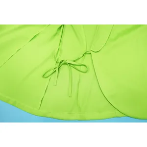 Detailed macro view of the adjustable tie-waist on a vibrant neon green blazer cardigan.