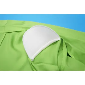 Close-up of internal white shoulder pad detail on a bright green solid color blazer jacket