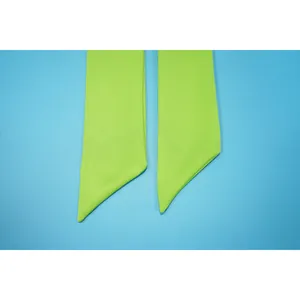 Close-up macro detail of the vibrant lime green tie-up belt for women's fashion suit
