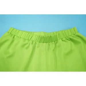 Macro detail shot of lime green wide-leg pants featuring a comfortable elastic waistband