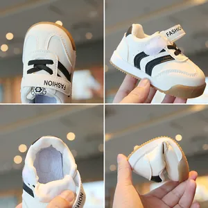 Comfortabele zachte witte babysneakers met zwarte strepen en een flexibele zool