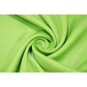 Macro close-up of vibrant lime green fabric texture showing smooth drape and weave