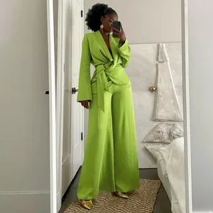 Lime green two-piece suit set with wrap blazer and wide-leg trousers mirror selfie