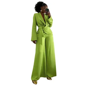 Elegant lime green two-piece fashion suit with wrap tie blazer and wide-leg trousers for women