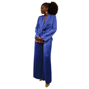 Detail of elegant blue satin wrap-tie blazer and wide-leg trouser suit on a female model