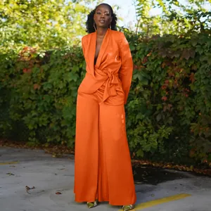 Elegant bright orange satin two-piece set with wrap tie blazer and wide-leg trousers