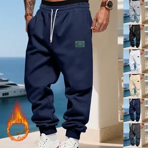Navy blue men's fleece-lined joggers featuring a stylish patch and elastic drawstring waist