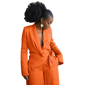 Chic orange two-piece suit set featuring a tie-front blazer and matching wide-leg pants