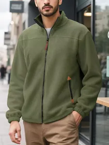 Close-up of men's olive green polar fleece zip-up jacket in an outdoor street setting