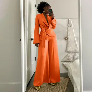 Sophisticated orange two-piece set featuring wrap top and wide-leg trousers for women