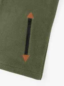 Detail shot of men's olive green polar fleece sweatshirt with zipper and leather patch.