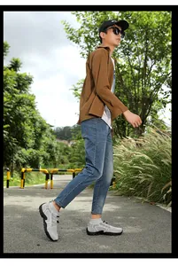 Male model wearing grey breathable outdoor hiking and wading shoes on a nature trail