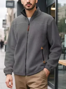 Detail view of men's grey fleece zip-up jacket showing style and fit for winter