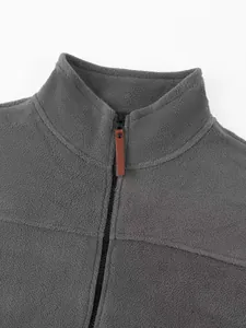 Close-up detail of gray polar fleece sweatshirt featuring a durable front zipper pull