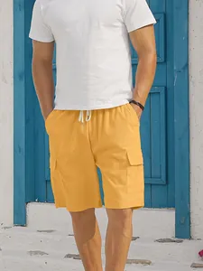 Close-up of yellow corduroy cargo shorts featuring side pockets and a drawstring waist