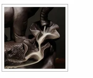 Detailed view of smoke flowing through lotus leaves on elephant incense burner