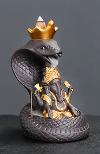 Close-up of Ganesha and cobra backflow incense burner showing realistic smoke effects
