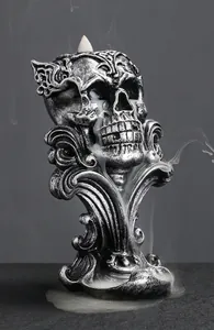 Macro shot of resin skull backflow incense burner with smoke flowing through the eyes