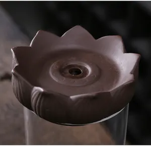 Macro close-up of a lotus-shaped purple clay incense burner part with a textured finish