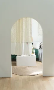 Cream cotton door curtain with yellow floral pattern and white ruffles in arched doorway