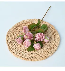 High-quality vintage 8-head artificial rose branch with realistic burnt edges on straw mat.