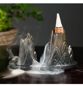 Atmospheric backflow incense burner with realistic smoke effect on mountain peaks