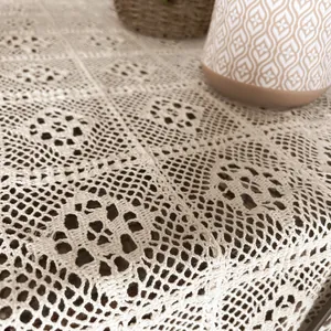 Detailed close-up of retro hollow lace crochet pattern on a beige table runner