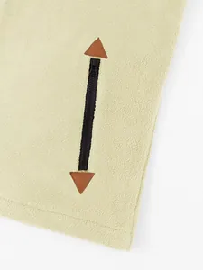 Detail of men's textured fleece sweatshirt zipper with brown leather triangle accents