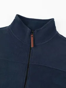 Close-up of navy blue polar fleece jacket with stand collar and zipper detail