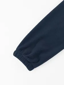 Close-up detail of the elastic cuff on a navy blue polar fleece sweatshirt for men.
