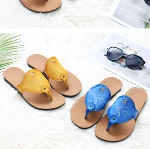 Close-up detail of stylish yellow and blue PU leather flip-flops for summer beach wear