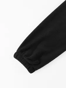Detail view of black polar fleece sweatshirt cuff showing elastic wrist and texture.