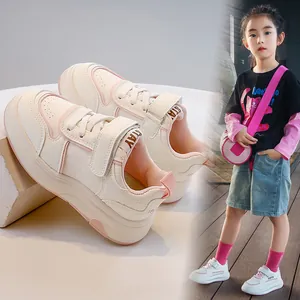 Sneakers bianche per bambini con accenti rosa e cinturini in velcro per lo sport.