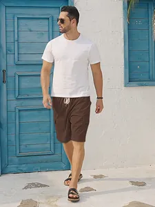 Detailed view of men's brown corduroy cargo shorts with drawstring waist and pockets.